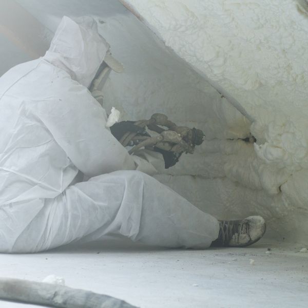 image of a man spraying foam insulation
