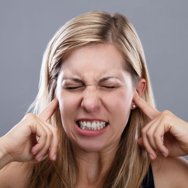 Women plugging her ears