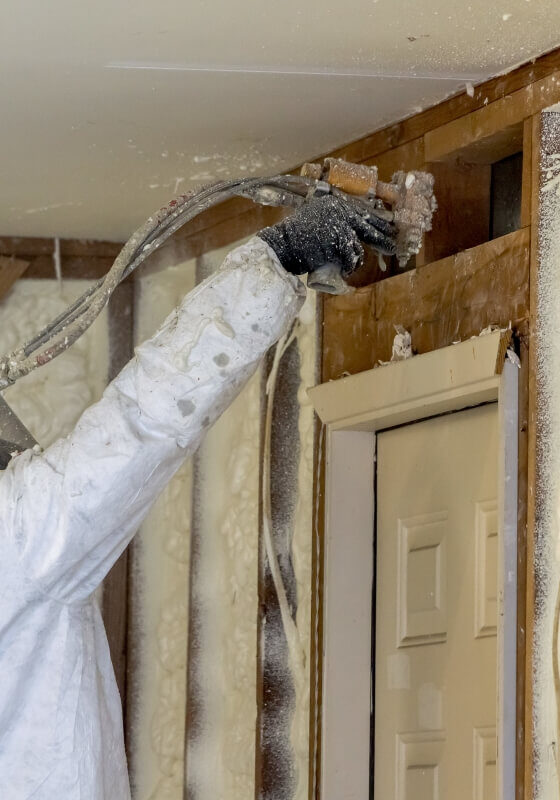 a person spraying foam insulation